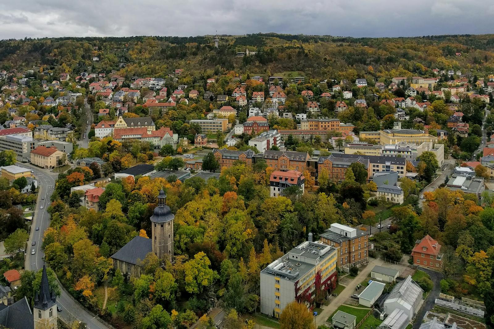 Aerial view of Jena, Germany showcasing colorful autumn foliage and historic architecture.