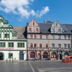 Vibrant facades of historical buildings in Weimar's main square on a sunny day.