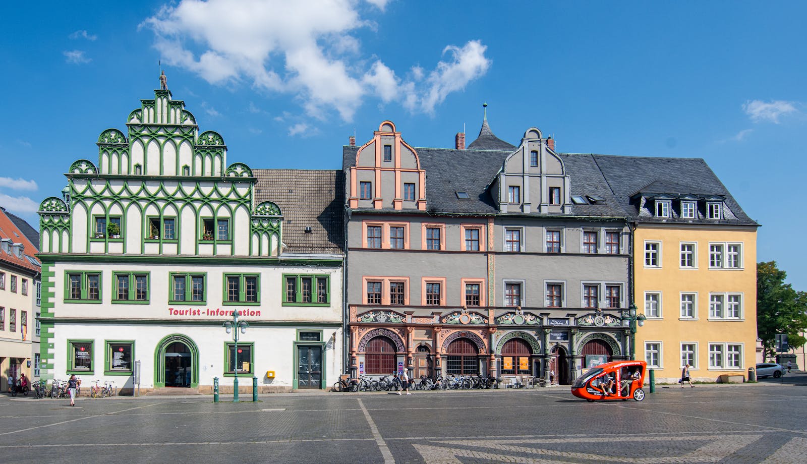 Vibrant facades of historical buildings in Weimar's main square on a sunny day.