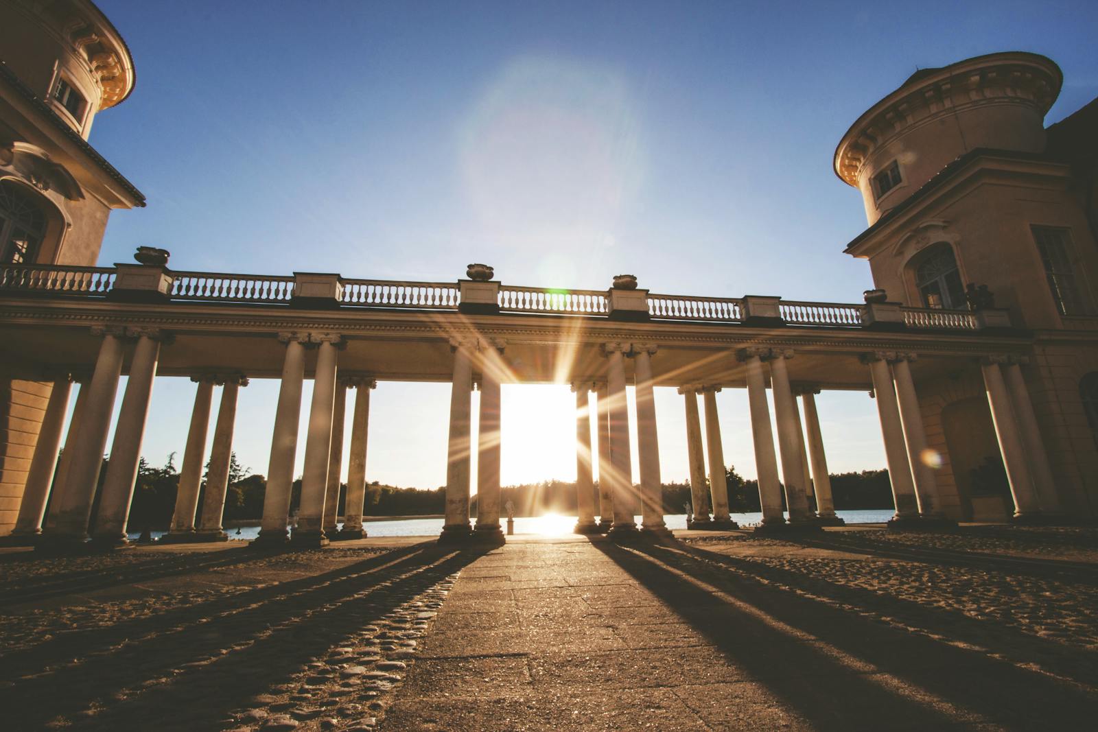 Capturing the dramatic sunset through majestic columns in Rheinsberg.