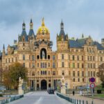 Stunning view of Schwerin Castle, a landmark in Germany, captured during autumn showcasing its grand architecture.