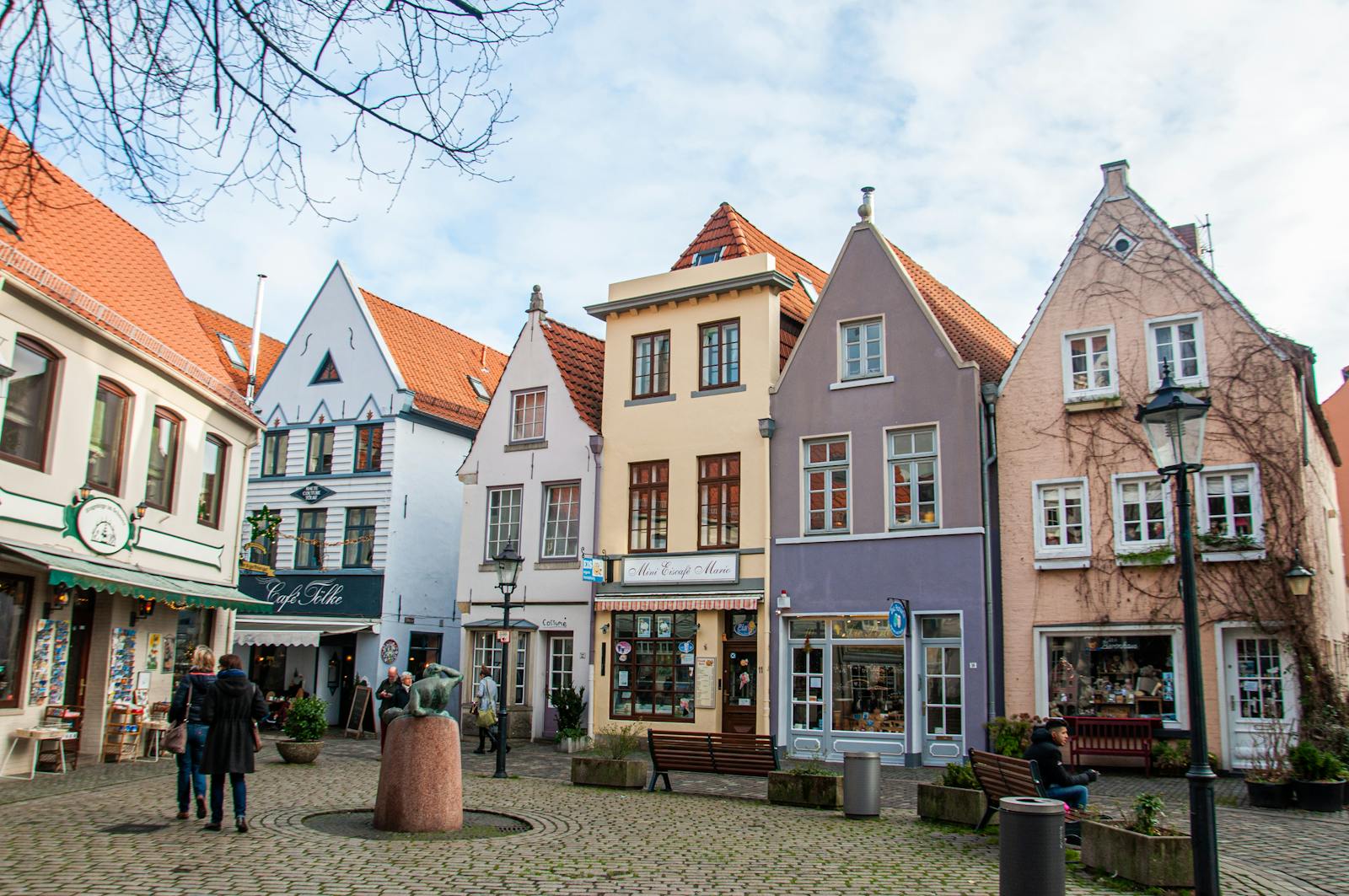 Picturesque Bremen street with colorful buildings and cobblestone path.