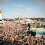 A lively scene at Oktoberfest in Munich with a massive crowd enjoying the festivities and attractions.